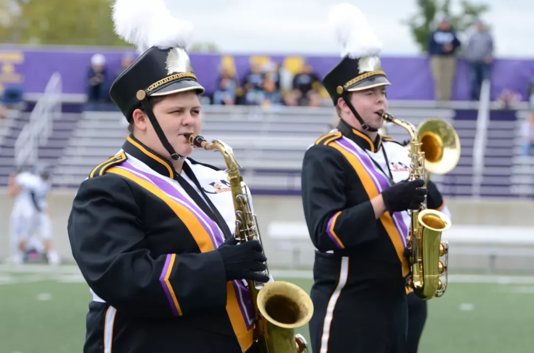 Saxophone players in AU Marching Band performing during football game